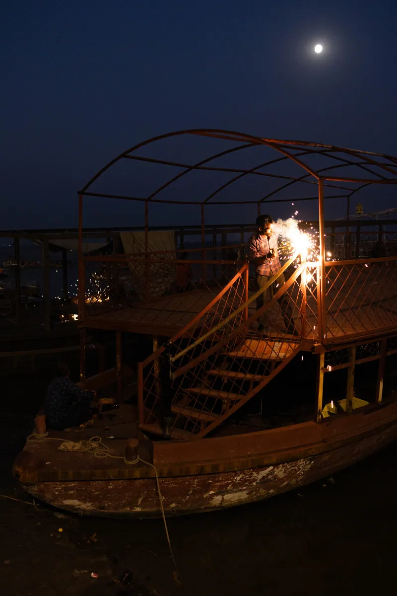 At night the riverbank lights up with ceremonial activities, and shipbuilders create new double decker crafts for tourist excursions.